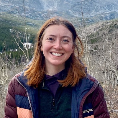 A picture of Julianne Reas in front of a mountain range.
