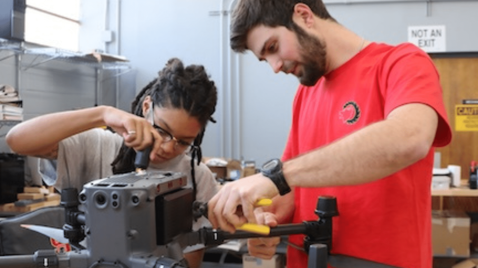 Alex and labmate Thomas work on a drone in their lab